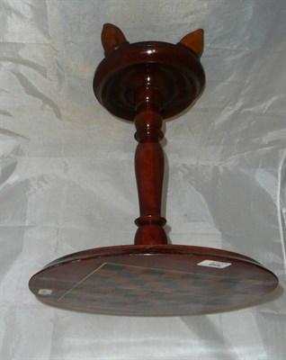 Lot 369 - A small pedestal games table on acorn feet