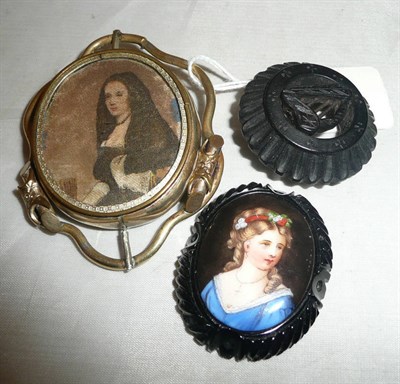 Lot 399 - A bog oak brooch, a jet and portrait panel (a.f.) and a swivel brooch