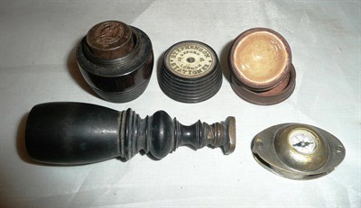 Lot 401 - A hand seal, a seal in a turned wooden case, a loupe/compass and a seal case