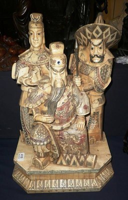 Lot 418 - A large bone carving of three warriors