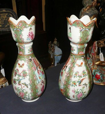 Lot 429 - A pair of Canton famille rose vases, with shaped rims