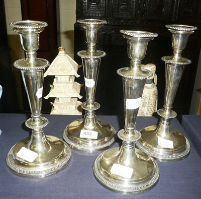 Lot 433 - A set of four silver plated candlesticks