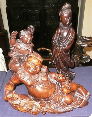 Lot 434 - A carved hardwood model of a female and two others