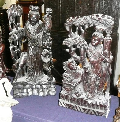 Lot 435 - Two hardwood carvings of figures with white metal inlay