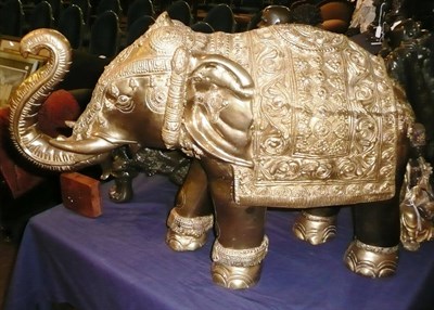 Lot 437 - A large brass model of an Indian elephant in ceremonial garb