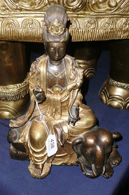 Lot 438 - A patinated and gilt bronze model of a deity seated on an elephant