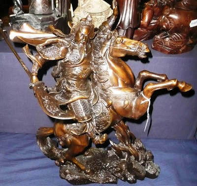 Lot 443 - A large patinated bronze model of a Samurai warrior on horseback