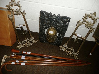 Lot 454 - A pair of brass table easels, a collection of walking sticks and an Eastern carved hardwood...