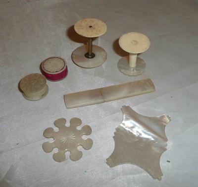 Lot 493 - Mother of pearl bobbins, needle case etc