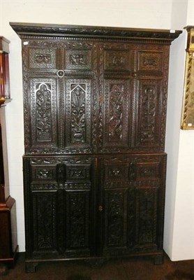 Lot 548 - Carved oak cupboard