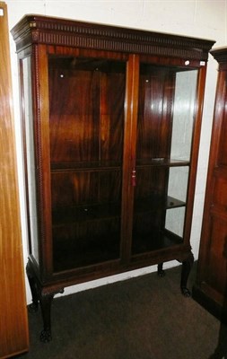 Lot 559 - A reproduction mahogany display cabinet on paw feet