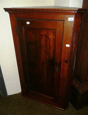 Lot 566 - A Georgian oak straight fronted wall hanging corner cupboard