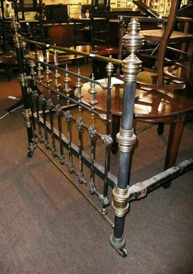 Lot 573 - 4'6" brass and black painted metal bedstead