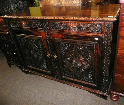 Lot 585 - A 19th century carved oak cupboard