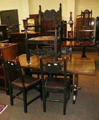 Lot 589 - An early 20th century oak refectory style table and five carved oak chairs (4+1)