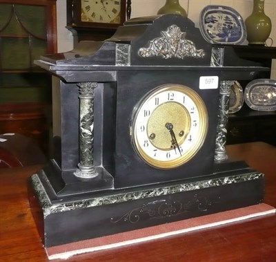 Lot 597 - A black slate mantel clock and key