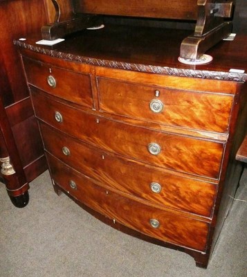 Lot 634 - A bow fronted four height chest of drawers with carved gallery