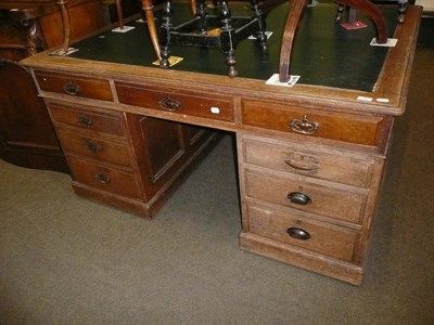 Lot 640 - An early 20th century oak pedestal partners desk