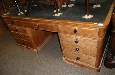 Lot 643 - An early 20th century pine pedestal partners desk