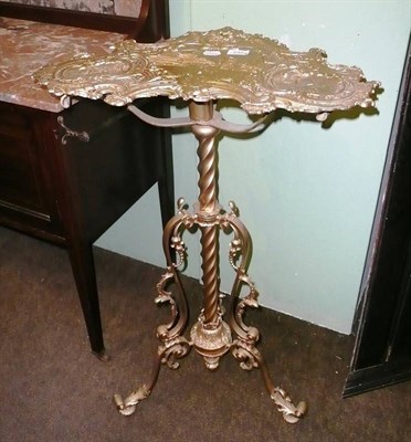 Lot 648 - A gilt metal pedestal table, top with cast decoration of buildings