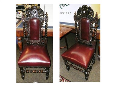 Lot 655 - A pair of carved oak side chairs with barley twist supports and armorial top