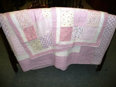 Lot 705 - A pink quilt and two similar smaller quilts