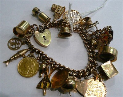 Lot 1 - A rose gold curb and lock bracelet hung with twenty four charms, including a 1918 full sovereign, a
