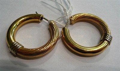 Lot 38 - A pair of 18ct two colour gold hoop earrings