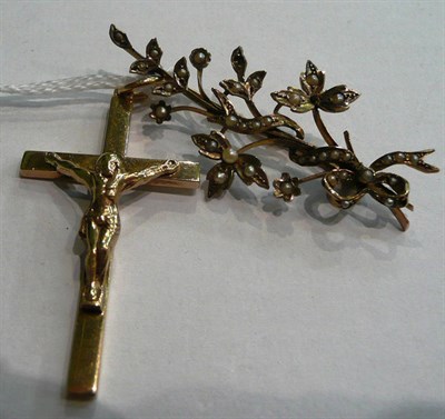 Lot 45 - A 9ct gold crucifix pendant and a seed pearl set floral brooch, stamped '9CT' (2)