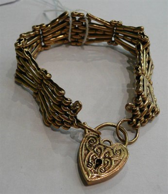Lot 58 - A gate link bracelet stamped '9.375' with a patterned padlock