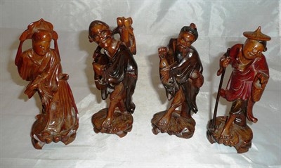 Lot 121 - Four Japanese carved hardwood figures of men and deities