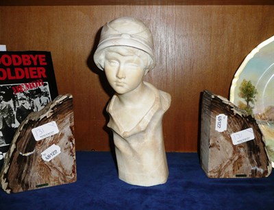 Lot 131 - An alabaster bust of a boy and a pair of petrified wood bookends from Australia
