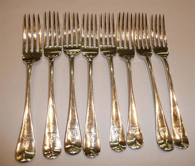Lot 142 - A composite set of eight silver Old English pattern table forks engraved with a crest, London...