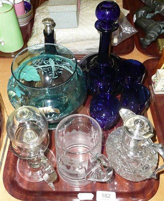 Lot 182 - A blue glass decanter, four glasses, bottle with stopper, enamelled glass vase, a mug etched with a