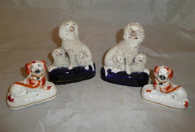 Lot 217 - A pair of Staffordshire poodle groups and a pair of Staffordshire dogs