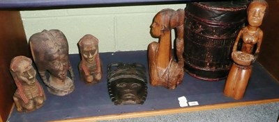 Lot 248 - A collection of Nigerian and other carvings of figures, a drum/container and a mask