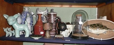 Lot 250 - A shelf of decorative items including Studio pottery, Denby lambs, cherub clock under a glass dome