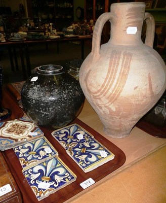 Lot 312 - A terracotta two handled amphora and a black glazed vase and five tiles