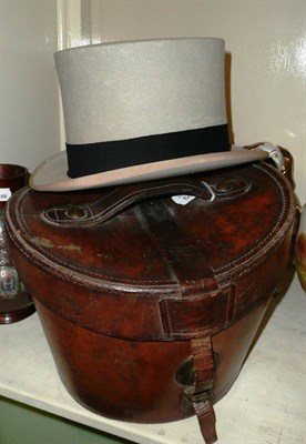 Lot 329 - A brown leather hat box by Henry Heath with red linings and grey felt top hat