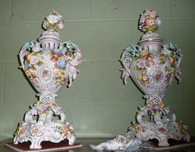 Lot 331 - Pair of German floral encrusted cherub twin handled vases with covers and stands