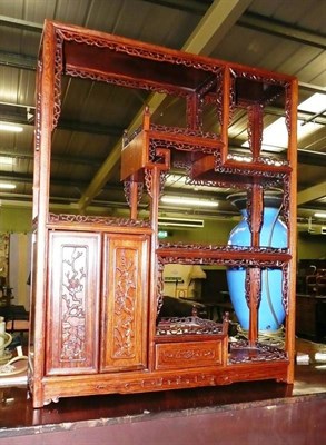 Lot 332 - A Chinese carved hardwood display stand