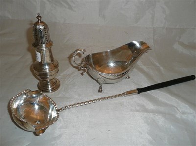 Lot 363 - A silver caster, sauceboat and toddy ladle