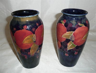 Lot 388 - Pair of William Moorcroft pomegranate vases on blue ground