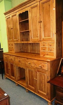 Lot 472 - A large pine Welsh dresser with an arrangement of cupboards and drawers