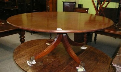 Lot 495 - A reproduction mahogany circular coffee table on four reeded down swept legs with brass toes