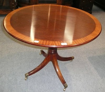 Lot 505 - A reproduction mahogany and satinwood banded circular tripod table on turned column support...