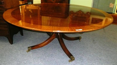 Lot 512 - A large reproduction mahogany and satinwood banded circular dining table on square platform...