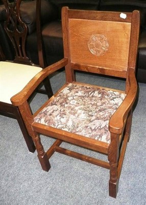 Lot 529 - A oak open armchair, carved to the back leg with a cat eating a mouse