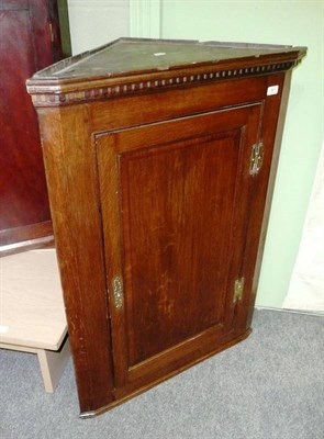 Lot 561 - George III oak hanging corner cupboard