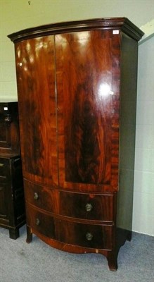 Lot 568 - A mahogany Georgian style bow front wardrobe